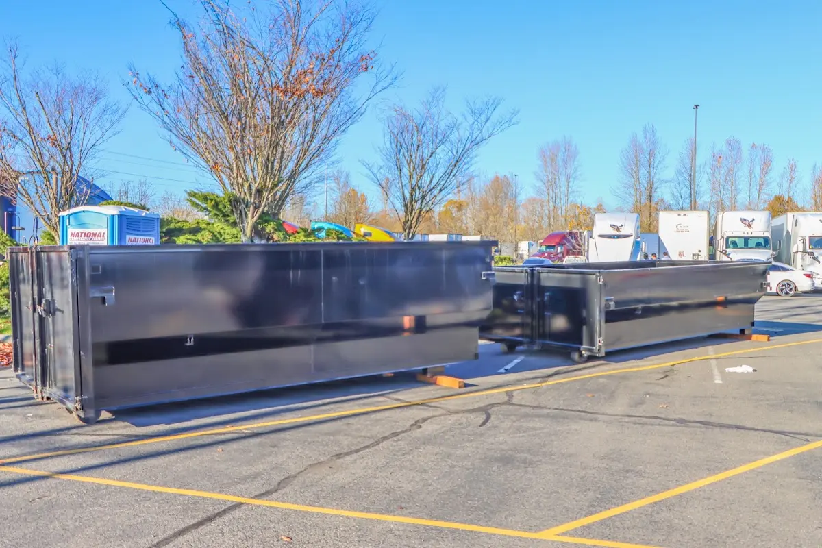 Professional dumpster rental service with roll-off container on residential driveway in Forest Park